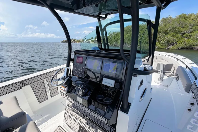 Slide: The Image of 2021 Wellcraft 302 Fisherman boat interior with advanced navigation system on open water. - 15