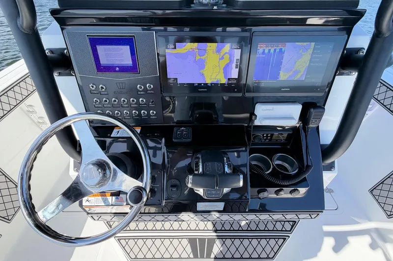 Slide: The Image of 2021 Wellcraft 302 Fisherman helm with advanced navigation displays and controls. - 16