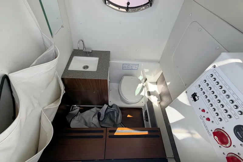 Slide: The Image of Interior of 2021 Wellcraft 302 Fisherman boat with sink, toilet, and control panel. - 17