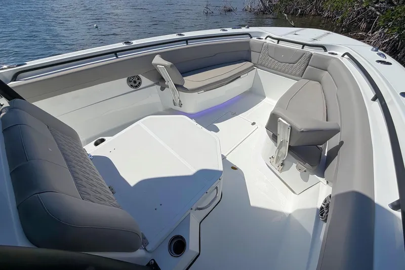 Slide: The Image of 2021 Wellcraft 302 Fisherman boat interior with cushioned seating and water view. - 19