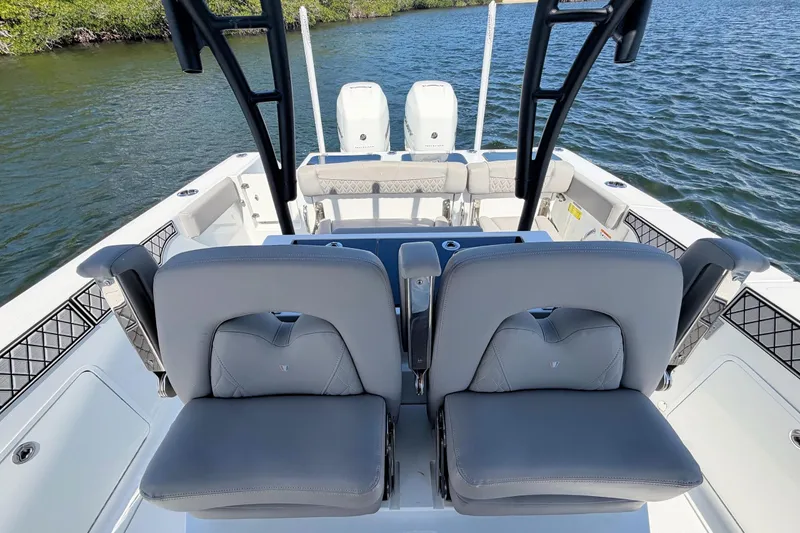 Slide: The Image of 2021 Wellcraft 302 Fisherman boat interior with dual seats and ocean view. - 9