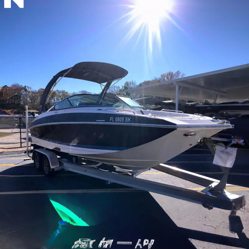 The Image of 2017 Regal 24 FasDeck boat on trailer under bright sun. - 0