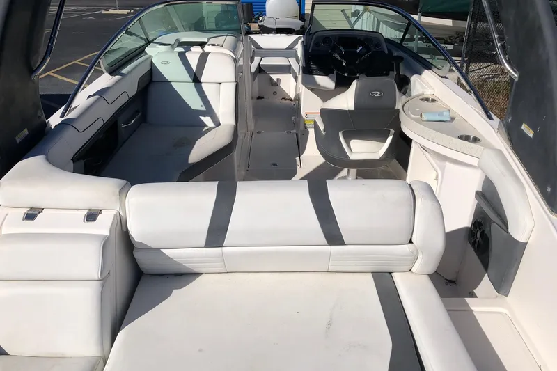 Slide: The Image of 2017 Regal 24 FasDeck boat interior with white seating and steering console. - 4