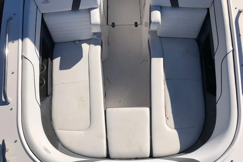 Slide: The Image of 2017 Regal 24 FasDeck boat interior with white seating and cup holders. - 8