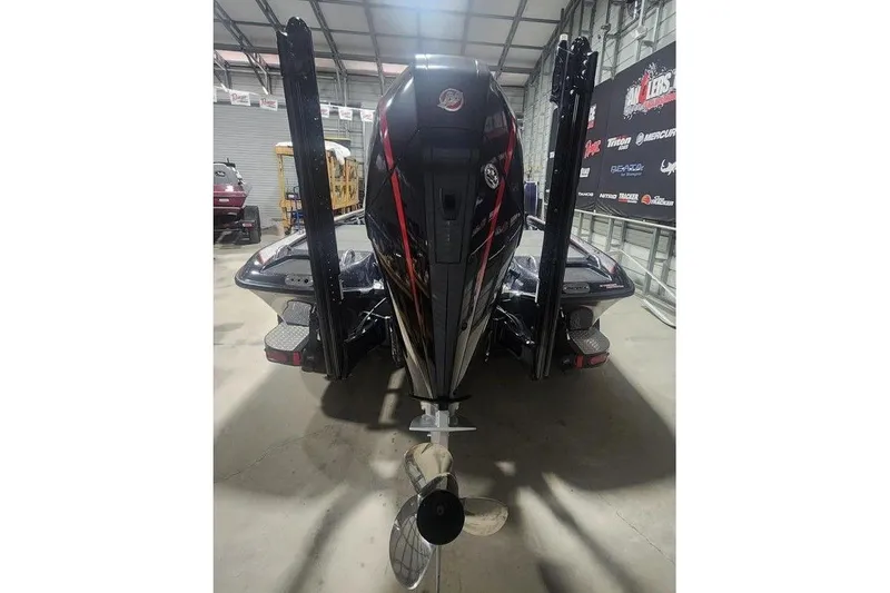 Slide: The Image of 2019 Phoenix 920 ProXP boat in a garage, rear view with motor and power poles. - 3