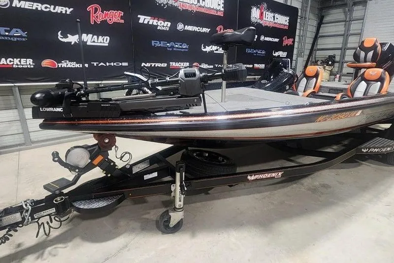 Slide: The Image of 2019 Phoenix 920 ProXP fishing boat on trailer in showroom with branded backdrop. - 4