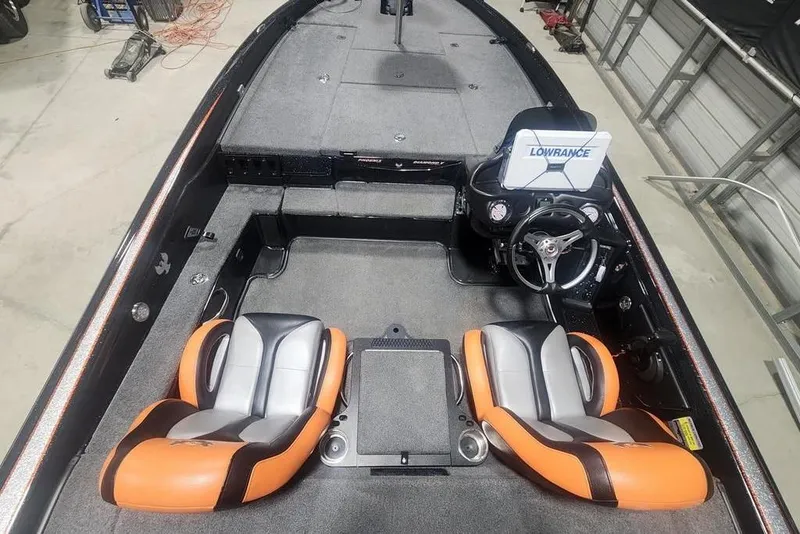 Slide: The Image of 2019 Phoenix 920 ProXP boat interior with orange seats and Lowrance navigation system. - 5