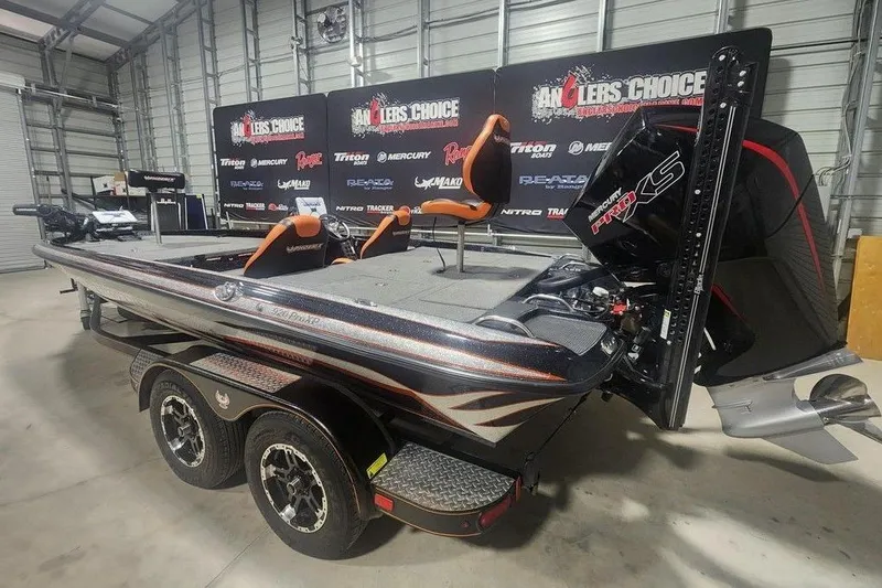 Slide: The Image of 2019 Phoenix 920 ProXP bass boat in showroom, featuring dual seats and powerful engine. - 6