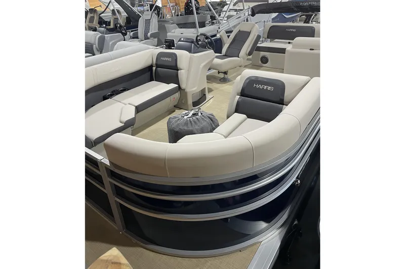 Slide: The Image of 2026 Harris Cruiser 210 SL pontoon boat interior with plush seating and modern design. - 2