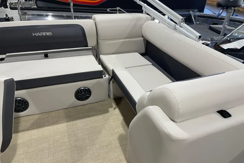 Slide: The Image of 2026 Harris Cruiser 210 SL boat interior with plush seating and integrated speakers. - 4