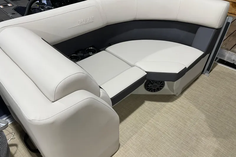 Slide: The Image of Luxurious seating on 2026 Harris Cruiser 210 SL boat, featuring cup holders and speaker. - 7