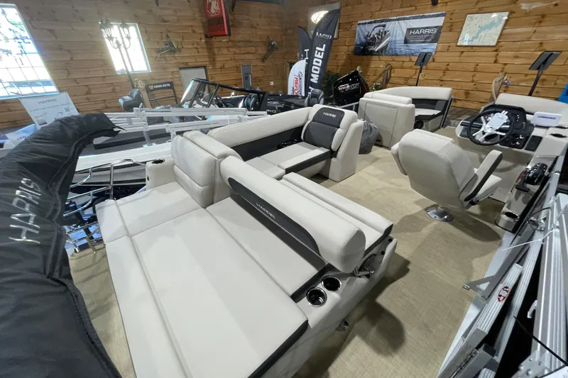 Slide: The Image of 2026 Harris Cruiser 210 SL pontoon boat interior with beige seating and modern dashboard. - 9