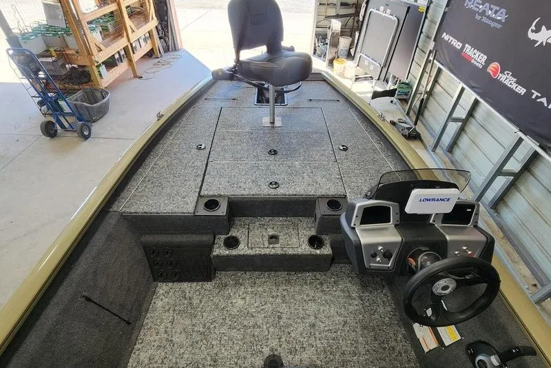 Slide: The Image of 2026 Tracker Pro Team 195 boat interior with steering console and seating in a garage. - 3