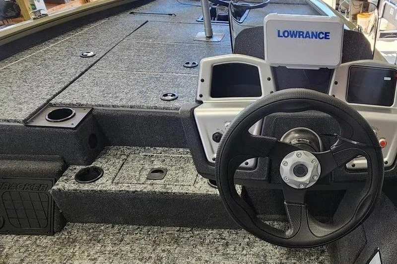 Slide: The Image of 2026 Tracker Pro Team 195 boat interior with steering wheel and Lowrance display. - 4