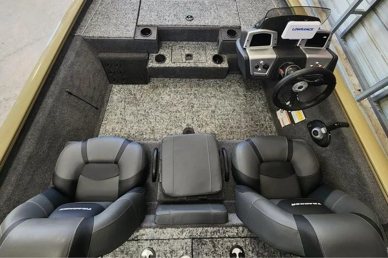 Slide: The Image of 2026 Tracker Pro Team 195 boat interior with dual seats and steering console. - 5