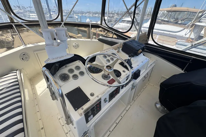 Slide: The Image of Cockpit of 1985 Hatteras 45 Convertible yacht with steering wheel and control panel. - 15