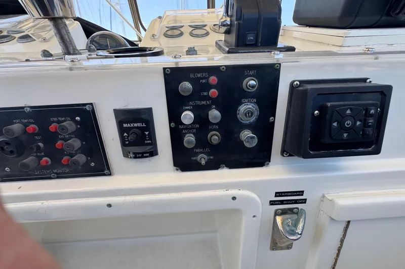 Slide: The Image of Control panel of a 1985 Hatteras 45 Convertible boat with various switches and gauges. - 19