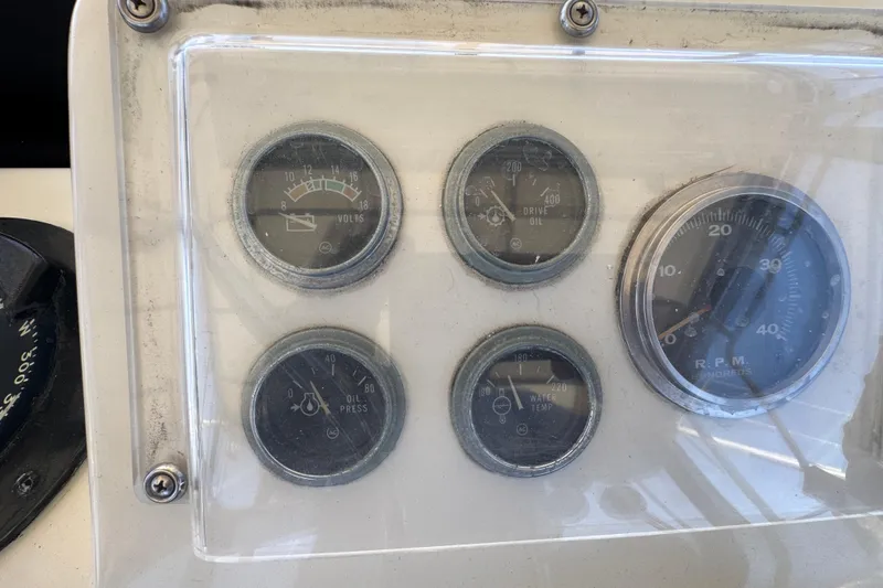 Slide: The Image of Dashboard gauges of a 1985 Hatteras 45 Convertible boat, showing volts, oil, and RPM. - 21