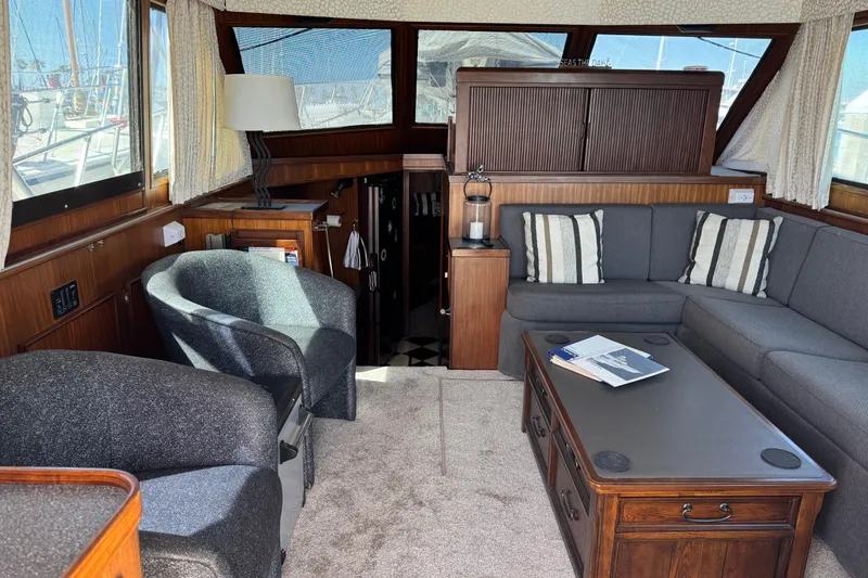 Slide: The Image of Interior of 1985 Hatteras 45 Convertible yacht with cozy seating and nautical decor. - 22