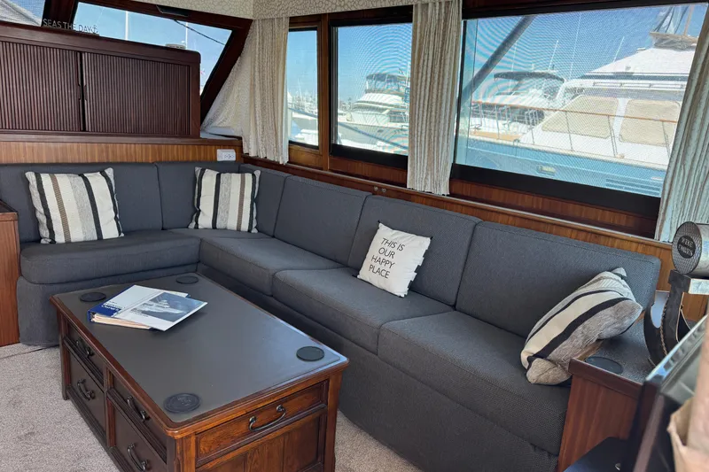 Slide: The Image of Interior of 1985 Hatteras 45 Convertible yacht with cozy seating and nautical decor. - 23