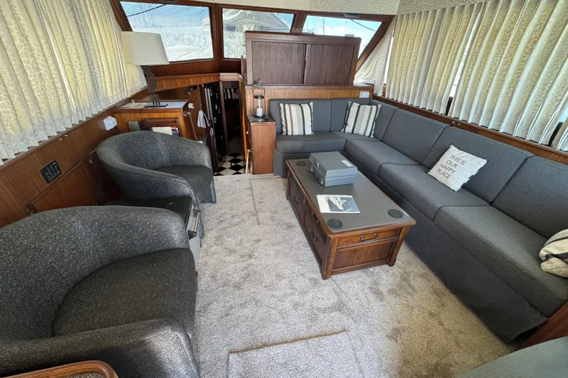Slide: The Image of Interior of 1985 Hatteras 45 Convertible yacht with cozy seating and elegant decor. - 28