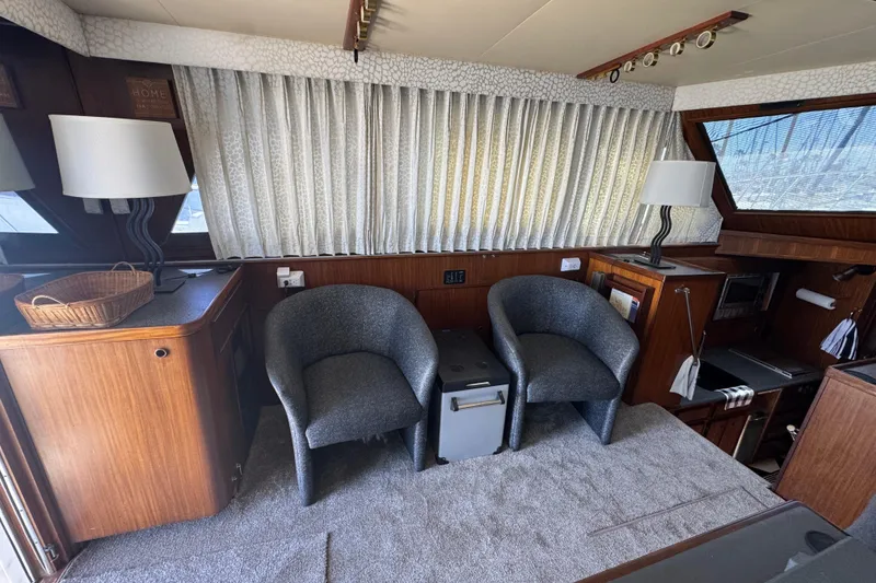 Slide: The Image of Interior of 1985 Hatteras 45 Convertible yacht with chairs and wooden cabinetry. - 29