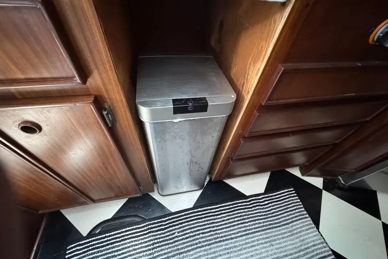 Slide: The Image of Trash bin in wooden cabinet space on 1985 Hatteras 45 Convertible yacht. - 35