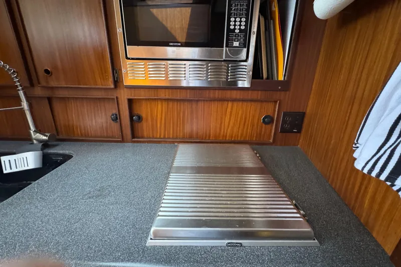 Slide: The Image of Galley kitchen in 1985 Hatteras 45 Convertible yacht with microwave and sink. - 38