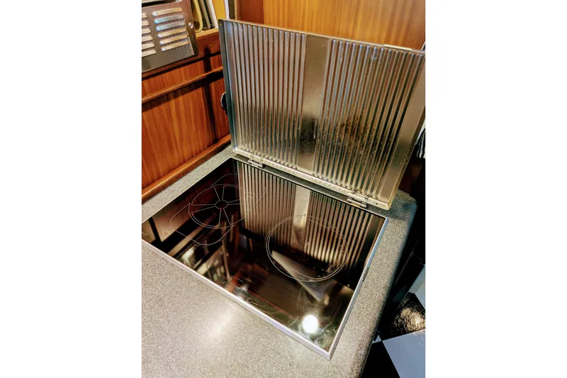 Slide: The Image of Stovetop in 1985 Hatteras 45 Convertible yacht kitchen, featuring sleek metallic design. - 39