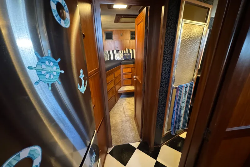 Slide: The Image of Interior of 1985 Hatteras 45 Convertible yacht with nautical decor and wooden cabinetry. - 42