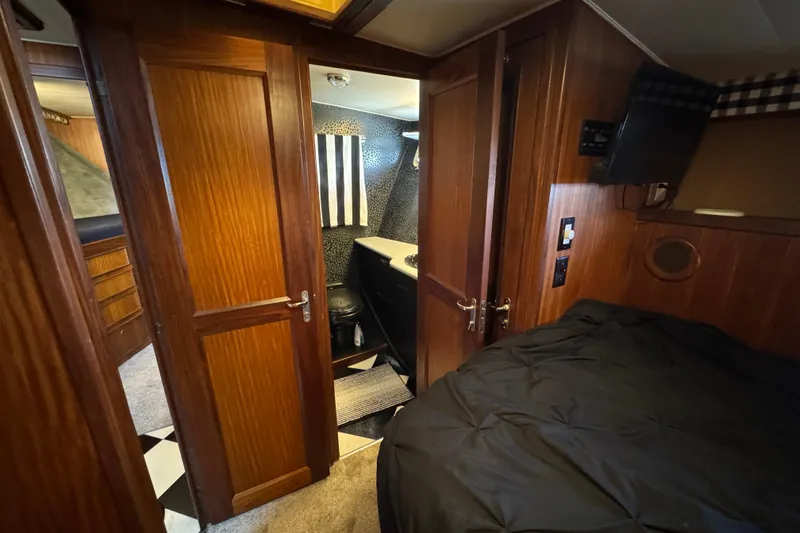 Slide: The Image of Interior of 1985 Hatteras 45 Convertible yacht with wood paneling and compact bathroom. - 46