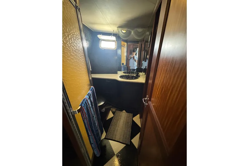 Slide: The Image of Bathroom interior of 1985 Hatteras 45 Convertible yacht, featuring a sink and window. - 47
