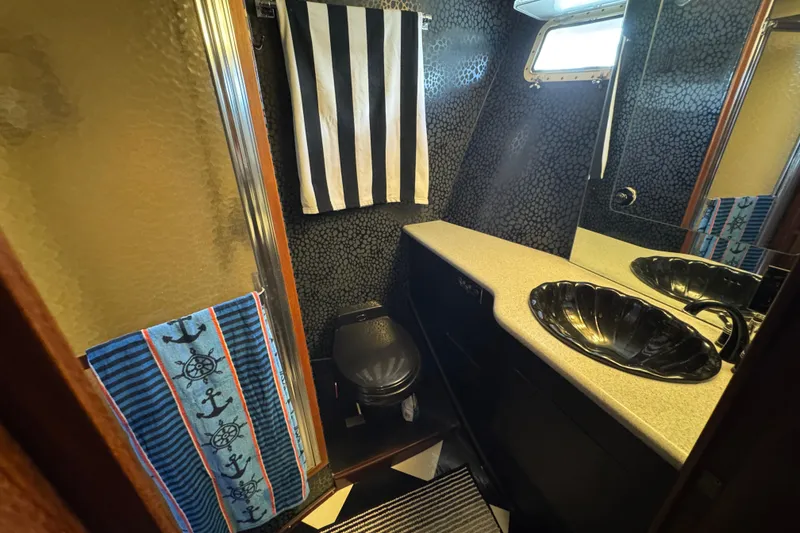 Slide: The Image of Bathroom interior of 1985 Hatteras 45 Convertible yacht with nautical decor. - 49