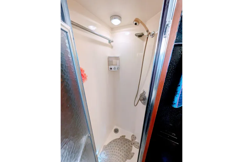 Slide: The Image of Shower area inside 1985 Hatteras 45 Convertible yacht, featuring a compact design and modern fixtures. - 50