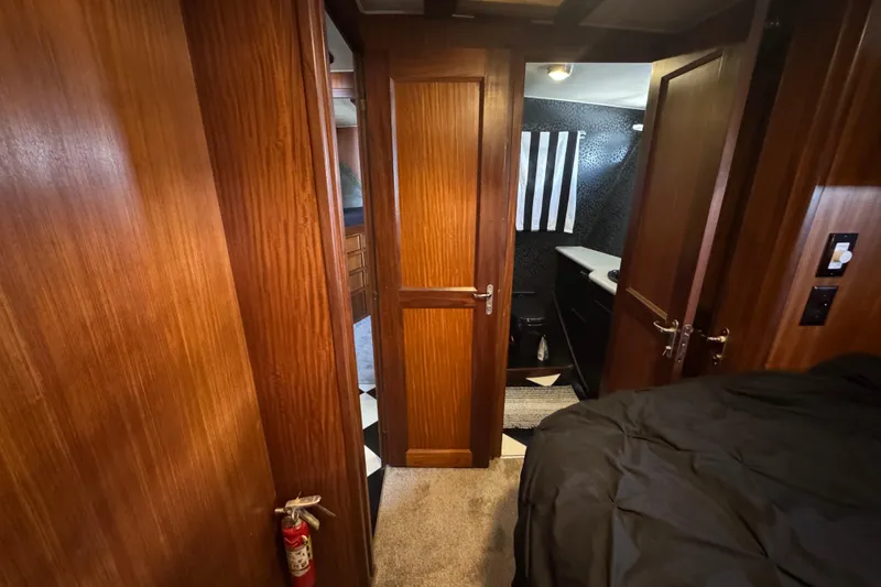 Slide: The Image of Interior of 1985 Hatteras 45 Convertible yacht with wood paneling and modern bathroom. - 51