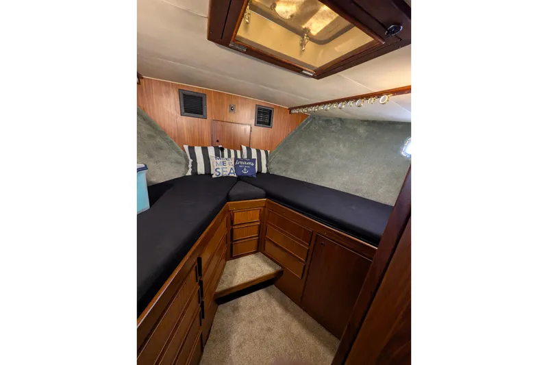 Slide: The Image of Interior cabin of 1985 Hatteras 45 Convertible yacht with cozy bedding and wooden cabinetry. - 53