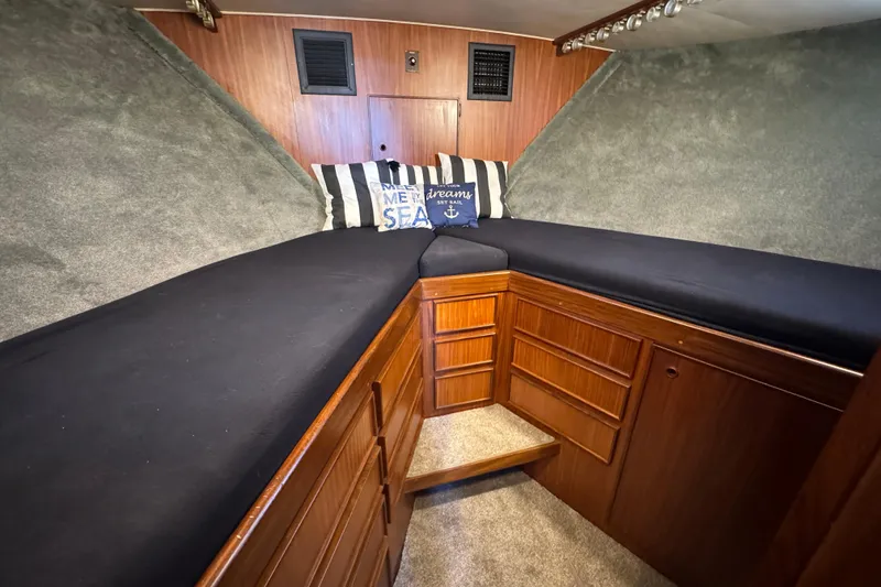 Slide: The Image of Interior cabin of 1985 Hatteras 45 Convertible yacht with cozy bedding and wooden cabinetry. - 54
