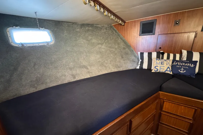 Slide: The Image of Cozy cabin interior of 1985 Hatteras 45 Convertible yacht with nautical-themed pillows. - 55