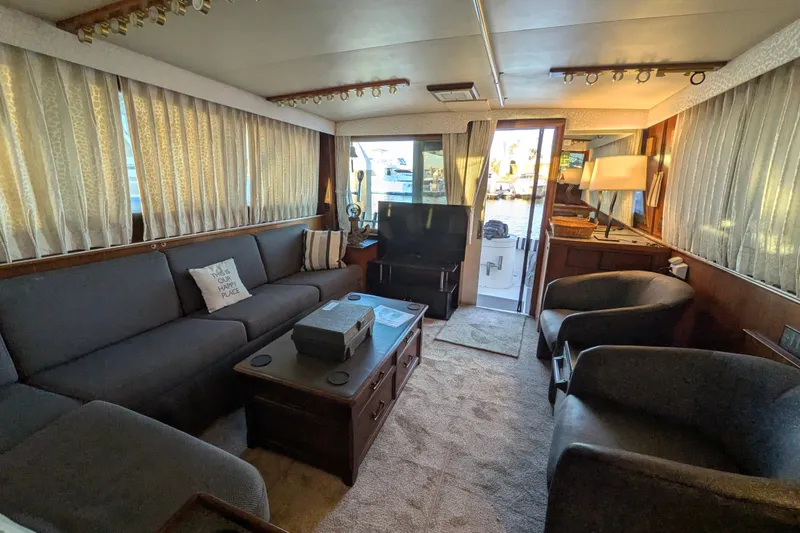 Slide: The Image of Interior of 1985 Hatteras 45 Convertible yacht with cozy seating and elegant decor. - 57