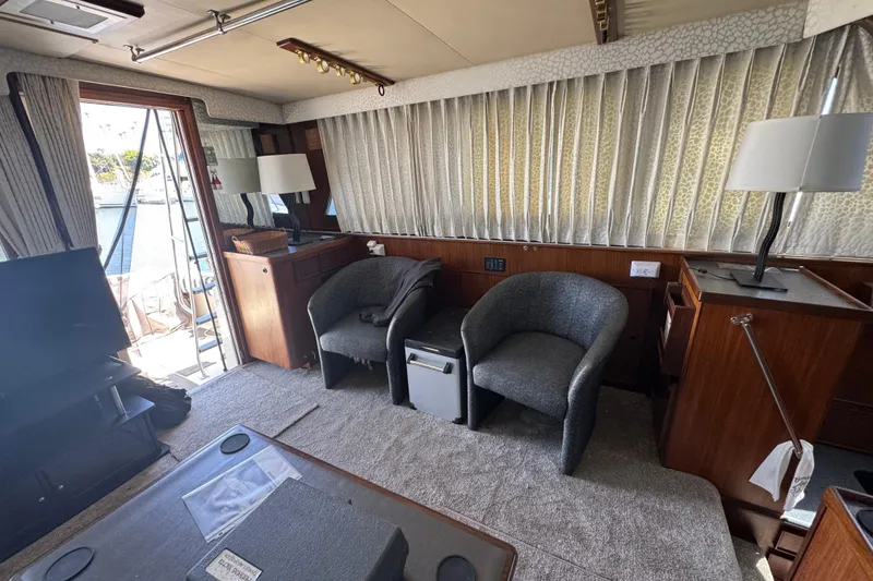 Slide: The Image of Interior of 1985 Hatteras 45 Convertible yacht with chairs and lamps. - 59