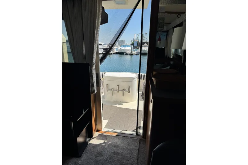 Slide: The Image of Interior view of 1985 Hatteras 45 Convertible yacht with marina backdrop. - 61