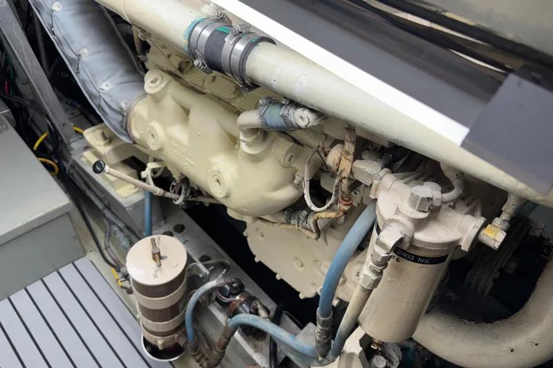 Slide: The Image of Engine compartment of a 1985 Hatteras 45 Convertible boat, showcasing mechanical components. - 64
