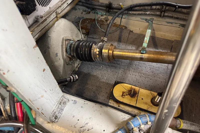 Slide: The Image of Engine room of a 1985 Hatteras 45 Convertible boat, showing mechanical components and wiring. - 66