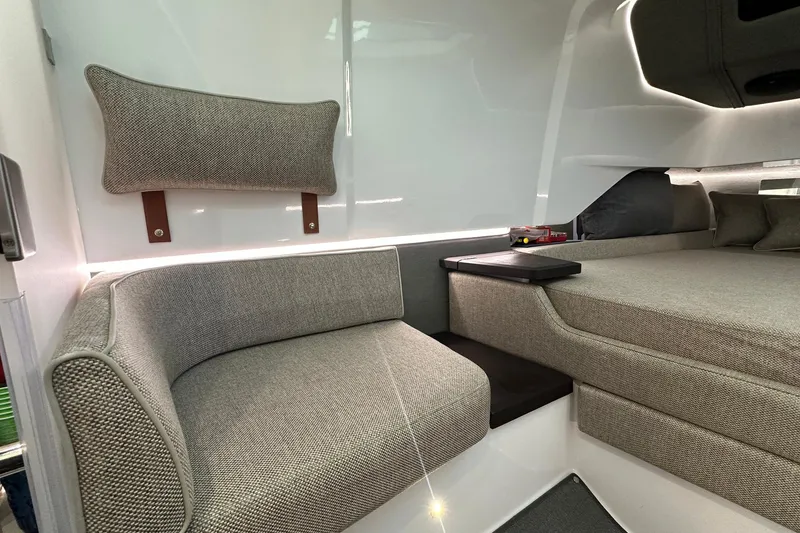 Slide: The Image of 2024 Axopar 37 Sun-Top interior with modern seating and sleek design. - 11