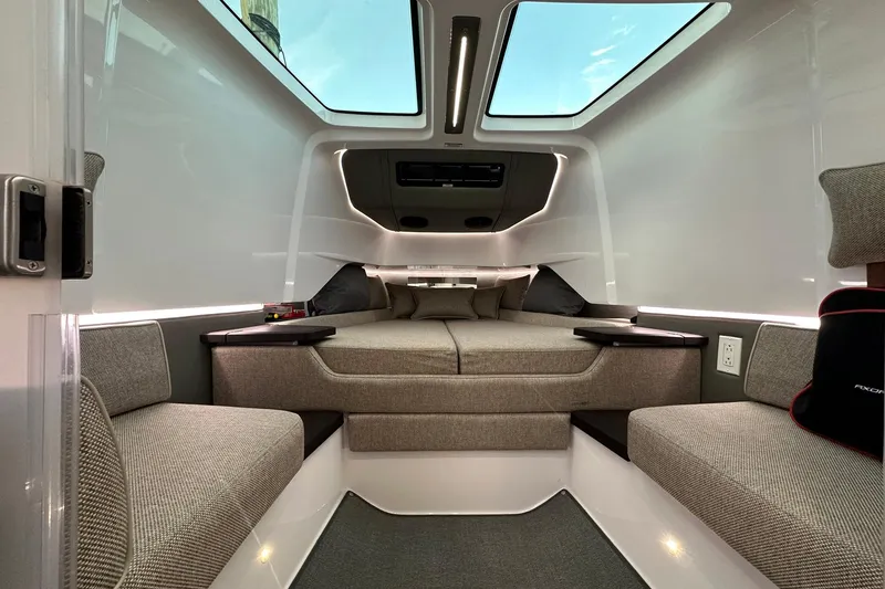 Slide: The Image of 2024 Axopar 37 Sun-Top cabin interior with modern design and comfortable seating. - 12