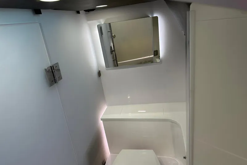 Slide: The Image of 2024 Axopar 37 Sun-Top boat interior bathroom with modern design and mirror. - 13