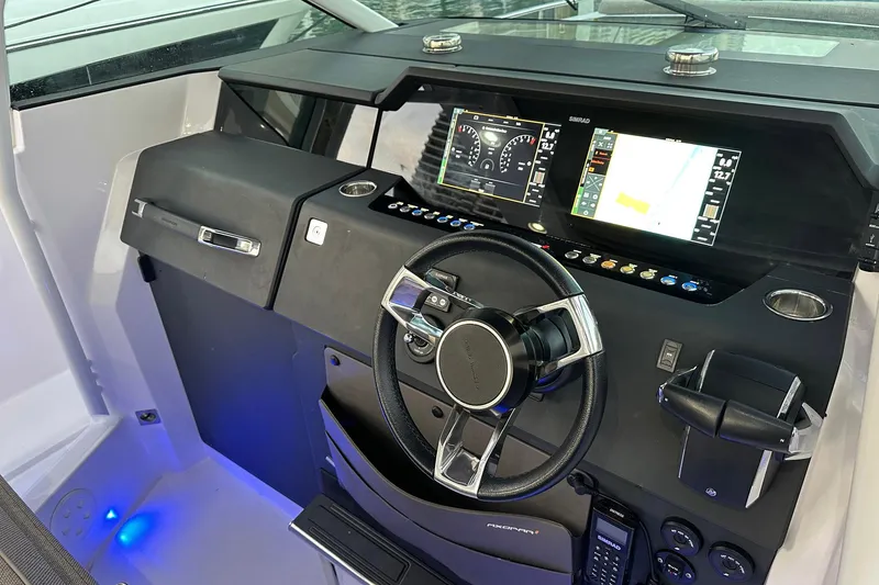 Slide: The Image of 2024 Axopar 37 Sun-Top helm with modern controls and digital displays. - 16