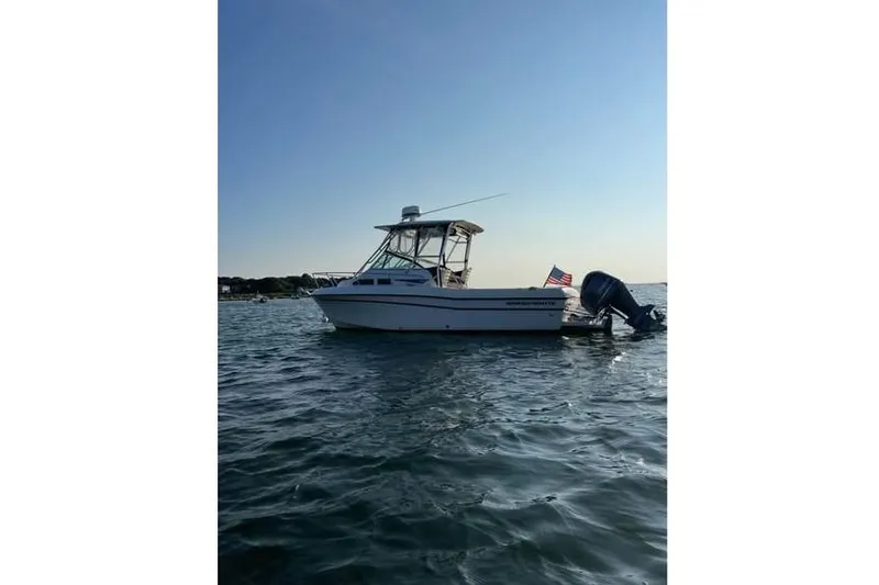 The Image of 2001 Grady-White Gulfstream 232 boat on calm water with American flag. - 1