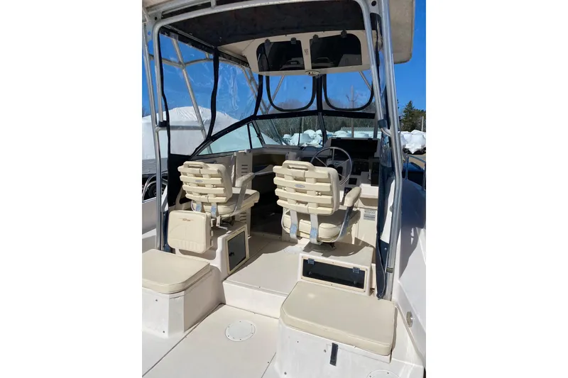 Slide: The Image of 2001 Grady-White Gulfstream 232 boat interior with helm and seating under canopy. - 10