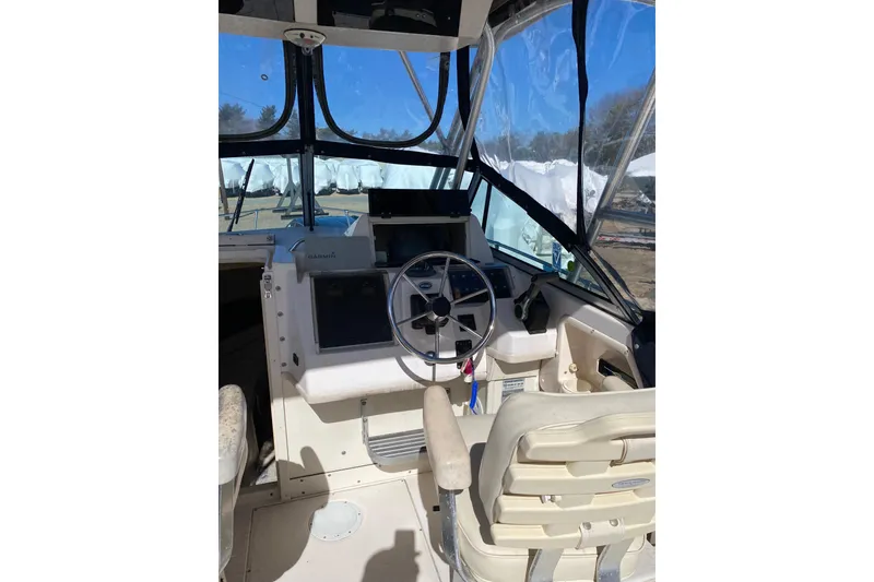 Slide: The Image of 2001 Grady-White Gulfstream 232 boat cockpit with steering wheel and navigation equipment. - 3